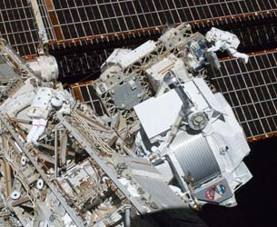 Astronauts installing AMS Alpha Magnetic Spectrometer